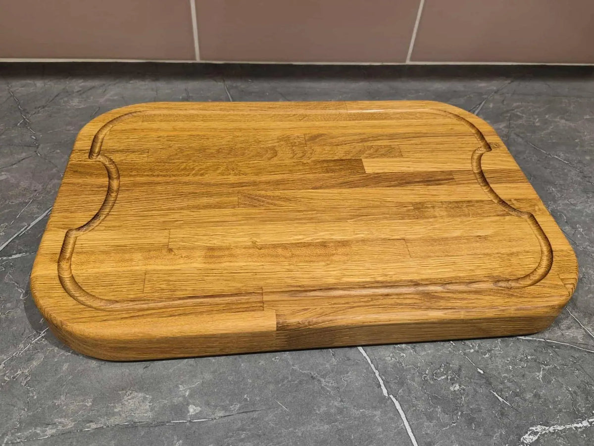 Wooden curved cutting board with juice groove
